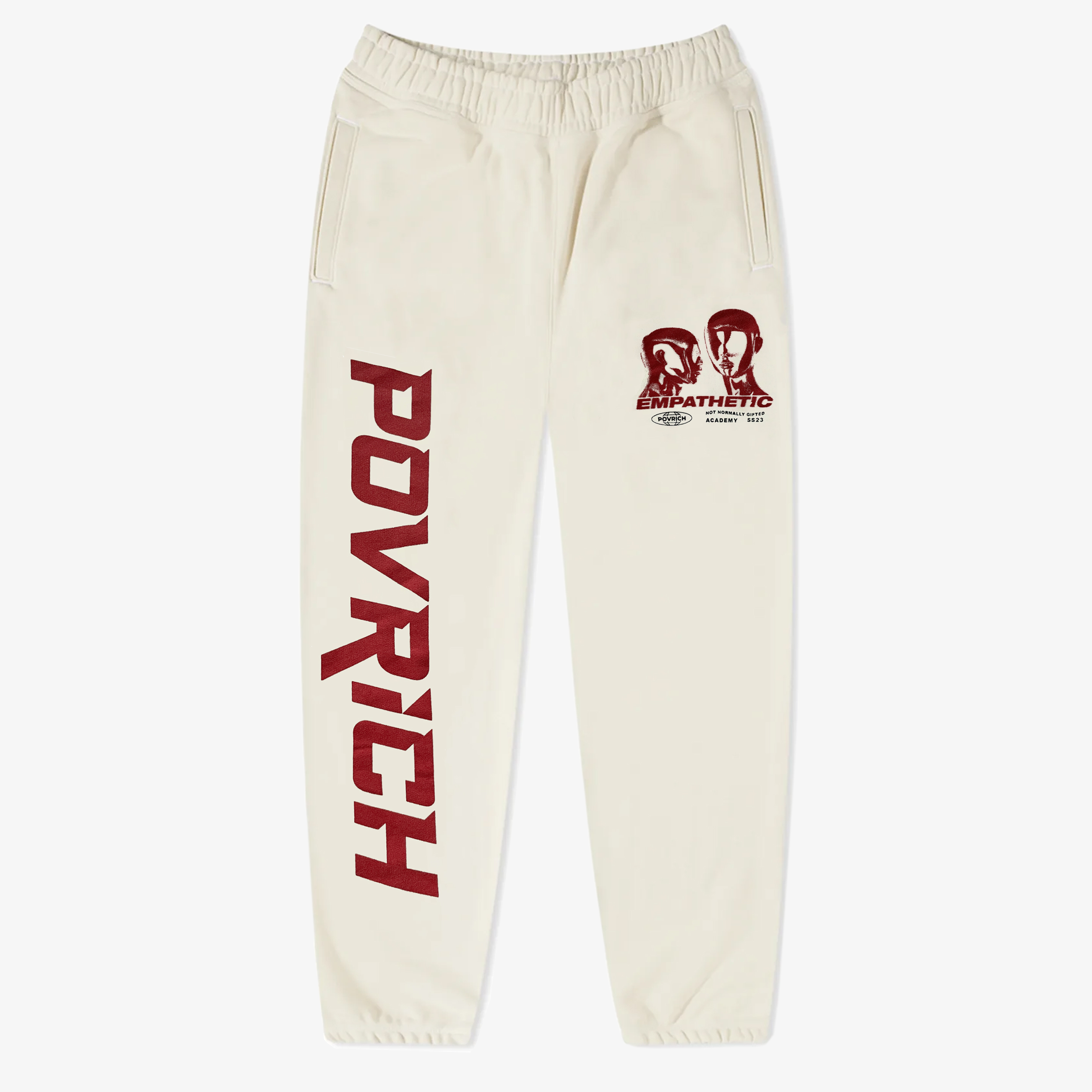 Empathetic Joggers by Povrich, featuring a tapered fit, elasticated waistband, and drawstring closure. Made from premium cotton material for maximum comfort. Creme color with red graphic designs on left & right legs. 